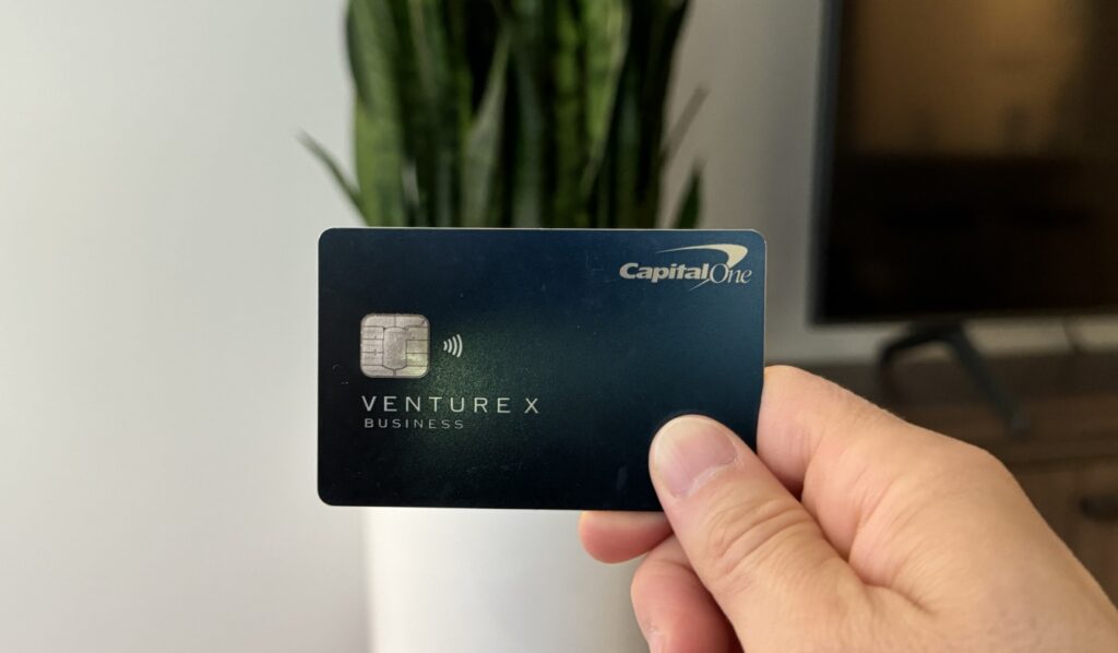 Nomadic Matt holding up his Capital One Venture X card